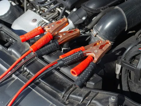 Keith's Towing technician jump-starting a vehicle battery