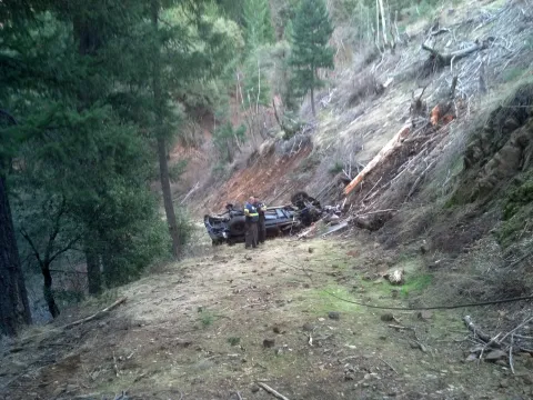 Keith's Towing crew recovering a rolled vehicle off an embankment