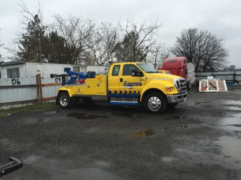 Keith's Towing wrecker truck parked at a job site