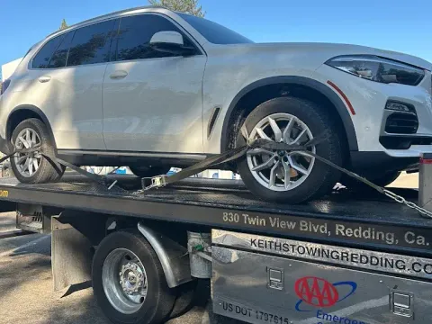 Keith's Towing truck towing an SUV