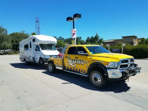 Keith's Towing truck towing an RV