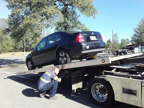 Keith's Towing crew loading a vehicle onto a flatbed